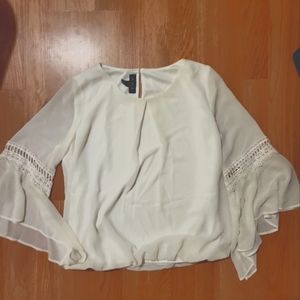 White blouse with lace detail and flowy sleeves